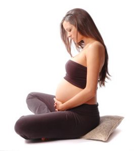 pregnant lady sitting and holding her belly